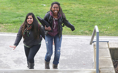 Highline College students walking and smiling on campus
